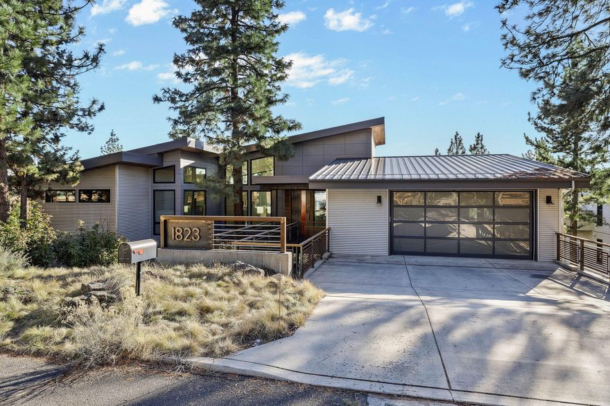 This home is a stunning showcase of exceptional design and masterful craftsmanship, featuring a striking blend of concrete and steel construction that maximizes breathtaking views. Sleek concrete floors throughout enhance the modern, minimalist aesthetic, while radiant floor heating ensures warmth and comfort year-round. The layout is thoughtfully crafted, offering a perfect balance of privacy and openness, with a clear distinction between the serene primary suite and the vibrant living areas. Clean, contemporary lines and an effortless flow create a space that is both visually captivating and incredibly functional. Experience the best of indoor-outdoor living with a retractable glass slider that opens to expansive spaces designed for ultimate relaxation and seamless entertaining. Additional touches, including a heated driveway for year-round convenience, and meticulously chosen details elevate this home into a true work of art.