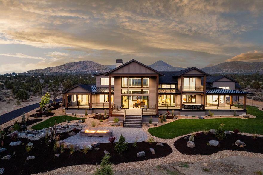 Stunning Grandview Estate in Powell Butte, Nestled on 9.78 Acres with Breathtaking Mountain Views. Meander up the paved driveway through the meticulously landscaped grounds and water features, you are greeted by the Elegant Stone exterior accents that seamlessly lead to the entryway adorned with floor-to-ceiling Stone and Metal art niches. Great Room and Dining Area boast expansive picturesque windows offering incredible views, complemented by oak wood floors and a soaring stone gas fireplace. Kitchen features a large Quartz Island, black and white Oak cabinets, Jenn Air appliances, Butler Pantry, and a Wet Bar. Primary Suite offers a Private Covered Patio and a Luxurious Primary Bath with Heated Floors, Slab Vanity and Shower, and Custom Walk-in Closet.  Ascend the Custom Stairway to the Floating Bridge where you will discover two Guest Suites. Step outside to the multiple Covered Patios and unwind by the Fire Pit. Lots of parking in the heated triple car garage and 50ft RV bay.