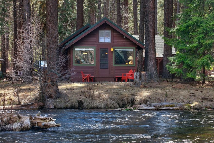 This exquisite 100-year-old USFS cabin in the Deschutes National Forest is located on the banks of the Metolius River in Camp Sherman. Situated on a large lot in a postcard setting, the cabin has a clear view and riverfront access. The cabin comfortably sleeps up to six people and is fully equipped with a bathroom, shower & full kitchen. Recent cabin updates include a new metal roof, new wood pellet stove and new water heater. Exceptional furnishings are included, and a fine collection of artwork is also available for sale. The property includes a large and airy work studio and separate storage shed. The adjacent studio space has ample room for entertaining or use as an artist's studio and includes a finished interior, new wood stove, vaulted ceilings and thoughtful furnishings. The main house is 912 sq ft and the detached studio is 425 sq ft. providing 1,337 total sq ft in living space.