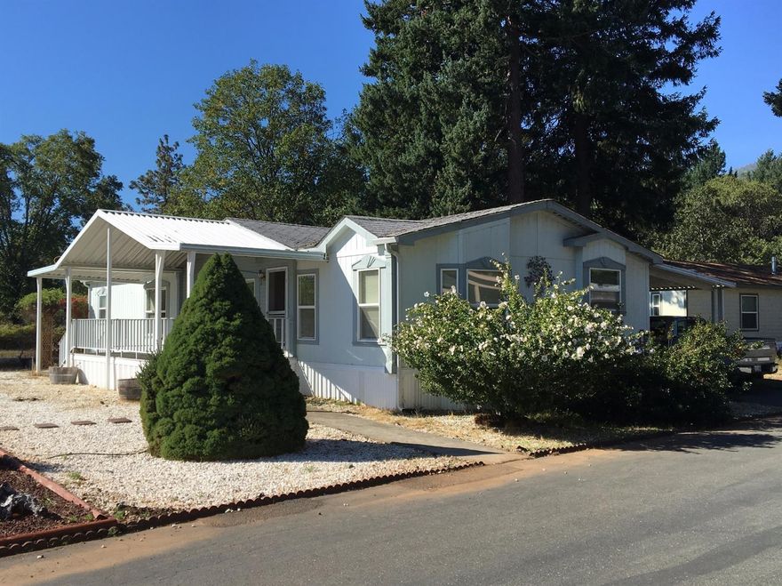 The seller will replace roof with a new 30 YEAR comp roof and vents at the close of escrow! Now, lets dive in! This limited edition Kit Home sits at the end of the quiet River Valley MH Park amongst tall trees where you feel in the middle of the Country. This is a very quiet area of the Park. The well designed open floor plan has plenty of windows to let the country feeling in. Covered front and back porches, low maintenance landscape with a deer fenced garden area. There is a handicap access ramp into the home from carport. 2 extra large bedrooms and a separate office with built in shelves. All appliances in the kitchen stay, including the new refrigerator. Newer washer and dryer also stay. The red mini-barn shed is ready for any craft or handyman work you enjoy. Enjoy the wildlife from your back yard as this double lot within the Park gives you a much bigger country feeling. Come Tour Today!