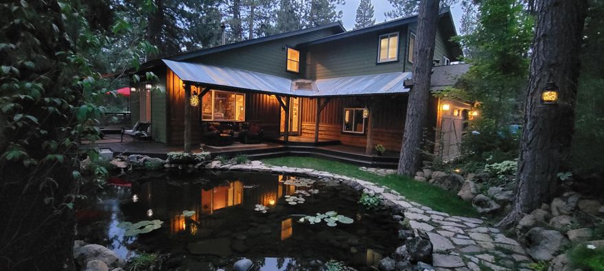 Stunning, updated 4 bd/3.5 ba custom-designed retreat! Enchanting setting w/Waterfall & pond on 1 acre in serene Valley Ridge Acres! Private boat launch to River, backs to Forest/Trails! 2 En suites! Spacious qtrs, roomy closets! Finished Basement for private, addl living qtrs/woodstove, Game Rm, galley kitchen or office area. Multiple decks for outdoor entertaining. Heated Shop/Office & 12 x16 corral at the back of the lot. Sunroom. Fresh ext/int paint. Kitchen w/copper accents, new stainless appl. w/upgraded range hood, Hickory cabinets & slide out shelving. Hammered Copper farm sink. Granite & Soapstone counters/tiled backsplashes. Center island & Oak hardwood floors in kitchen & dining rm. Venetian plaster. 18 ft ceiling in Living rm, French doors. New LVP flooring. Tile flooring in entry, baths. Dual vanities, jetted tub.  Central Vac, Heat pump w/electric air filters. Hot tub overlooks the private gardens, Fire pit. Two outbldgs/4 bays in back for all your toys, tools & storage!