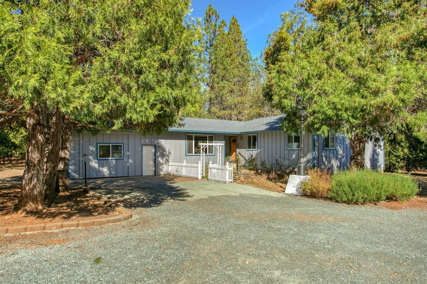 Rural retreat features privacy and comfortable single level living! Only 8 miles from town, this park like setting with 3 pasture areas for horses and 9 varieties of wine grapes will make you never want to leave home! House features 2 large family rooms, open floor plan, and natural light. Outdoor living features large flagstone patio and deck entertainment area and covered rear deck with hot tub. There's a 2 stall barn clean enough to live in, and an awesome studio that has a bar, commercial sink, and more. Great high speed internet access and would make great organic gardening set up. Or sit on the covered deck in your hot tub and just enjoy nature. Maybe turn this charming building into a guest house! (Buyer to do own due diligence regarding uses of brewery building). Also a greenhouse, hay shed, four car carport, fenced, cross-fenced, drip irrigation, fruit trees, raised garden beds, and more!