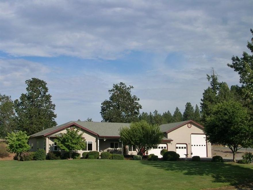 Immaculate, well cared for 1915 sq. ft. home on 2.5 acres just outside of town. 3 bedrooms, 2.5 baths, 3 car garage with 14x24 storage above, and a 40x16 RV bay, door is 12' wide and 14' high. Home faces west, has long range mountain views, and great sunsets! Light and bright inside, 9' ceilings, granite counters, hardwood floors, formal dining area adjacent to living room and kitchen, with a breakfast nook in the kitchen. Coiffured ceiling in the master bedroom, with a walk in closet. Double sinks and a jetted tub in the master bath. The garages and RV bay are nicely finished and inter connected. The property is connected to GPID. There is a great Trex deck for relaxing and entertaining off the back of the house, and a covered deck on the front. Well log shows 15 GPM. Town and the hospital are just minutes away!