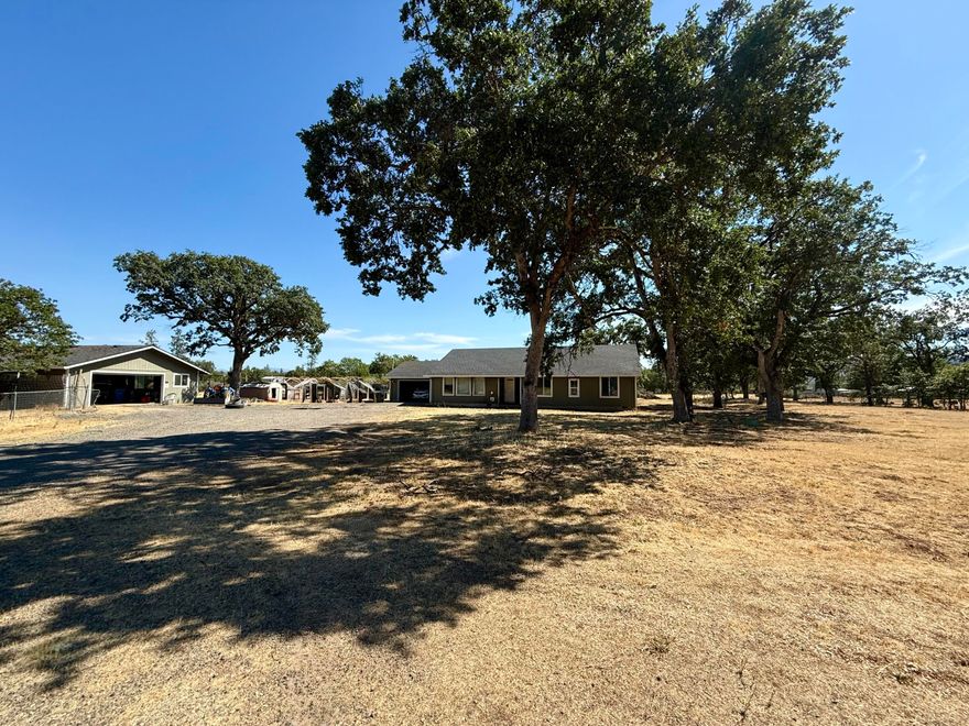 Great opportunity to own a home on 5 acres with an inground pool and detached garage/shop! Sizeable 4 bedroom, 2 bathroom, 1,920 sqft home in Sams Valley built in 2006. Interior of the home has a lot of potential with vaulted ceilings in the living and dining space, spacious kitchen, mudroom/laundry and large bedrooms. Additional detached oversized garage which can be used for storage or shop space. There is a back patio looking over the inground pool and outdoor views.