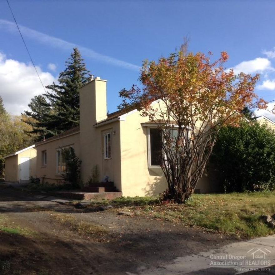 Charming, vintage 1940's 3 bedroom, 2 bath in a quiet MIDTOWN neighborhood. All new plumbing, updated bathrooms. New gas wall heat. Hardwood floors, big gas fireplace with tile surround, bay window, storage building, attached garage. Perfect home for the handy person. A little elbow grease will go a long way.