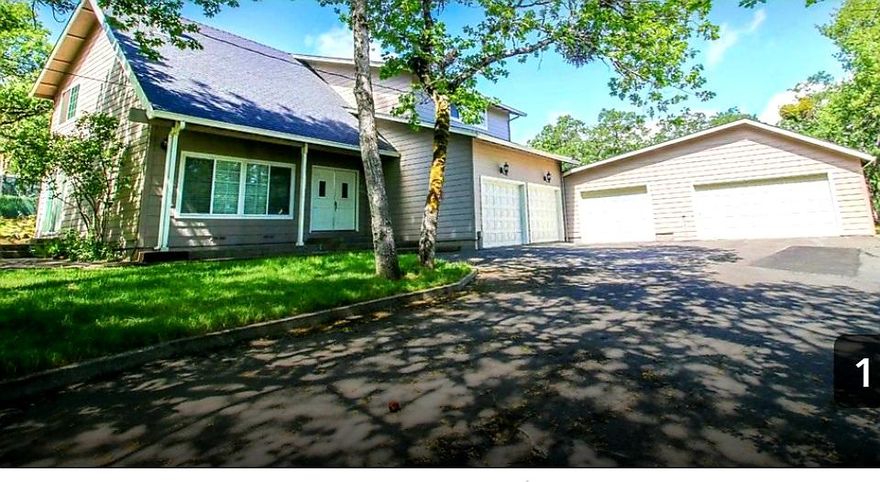 Excellent Jacksonville location, with a beautiful country setting, yet only minutes to down town, this special property offers so much on so many levels! Tucked perfectly on just over an acre of natural trees and slightly slopped landscaping, this contemporary two story offers 2,478 square feet of living space, with three upper level bedrooms, two full baths, and a reading den that could easily pass for an additional guestroom. The main double door front entry opens into a large living area, with pitched ceiling, open balcony, that adjoins the dinning room and country  style kitchen. The adjacent den and adjoining half-bath will be perfect for game night, or just relaxing with family and friends. Additional Property features include an attached, fully insulated - 6 car garage with shop area, and tons of room for storage, and a gated entry with a fully paved circular driveway. This special Jacksonville home is ready to go! You won't be disappointed.