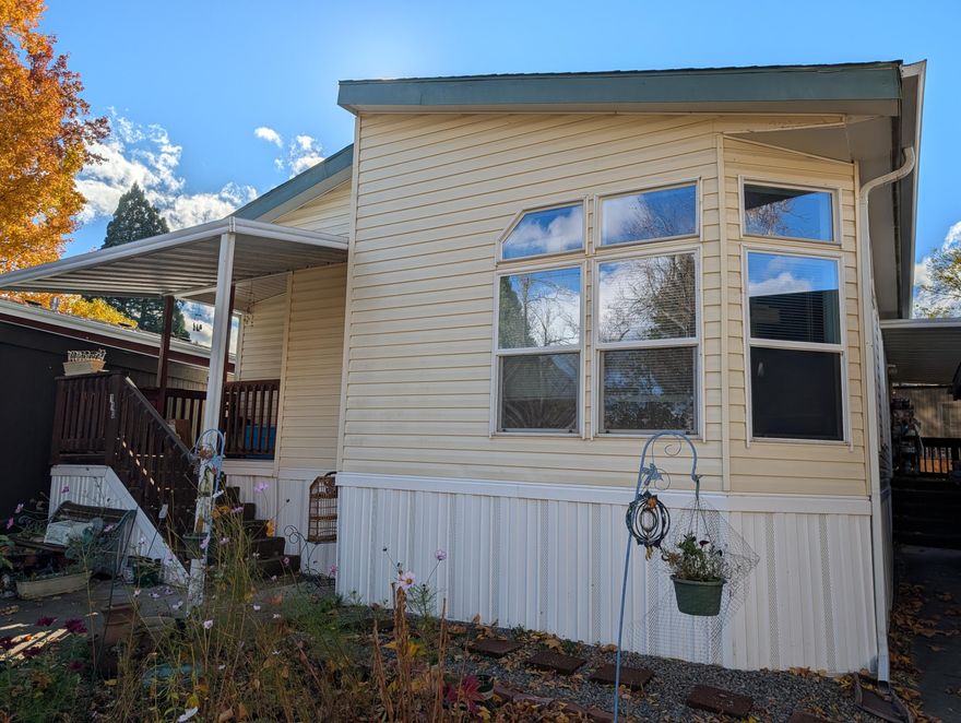 No Showing until 12/20 - Royal Mobile Estates, 55+ community. Spacious double-wide in Jacksonville's desirable Royal Mobile Estates Park. Built in 2000, well-maintained with a Lenox heat pump/furnace installed 2019 and a new 50g hot water heater installed in 2020, large kitchen with ample cabinets, stainless steel fridge and range, large laundry room, washer/dryer, covered deck, carport, and peaceful park with green space. Cottage style garden. Seller offers $5000 flooring credit with full-price offer. Just minutes from historic Jacksonville's shops, dining, and wineries. Comfortable, low-maintenance living with potential to make it your own.