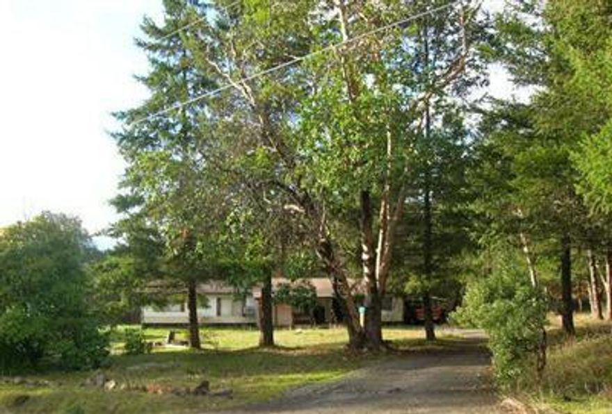 Taxes include manufactured home. Seller states home is of no value. Nice 1.27 acres in cul-de-sac. Septic hasn't been inspected but records show permitted for a 3 bedroom. Seasonal creek. 20gpm well per log - Salt well in area of salt wells. Neighbors have installed water tanks. Orchard and circular driveway -Buyer to do own due diligence. Sellers to give buyer credit at close to help cover cost of tank. Sellers will consider a trade.
