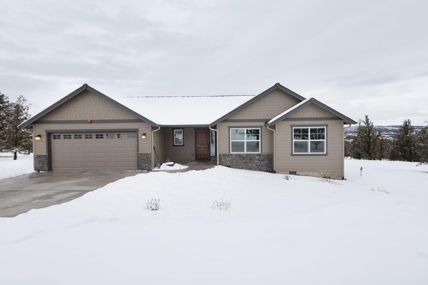 Perched gracefully upon 4.9  acres, overlooking Juniper Canyon, this well maintained 2019 New Era Commonwealth home is a delight.  Peeking out from behind mature Juniper trees  at the end of the road, the enticing privacy provided by the winding driveway is surprisingly surpassed by the incredible views once you exit your car.  Built with care and attention to details, the well-thought-out floorplan gives the homeowner the serenity inside that the landscape provides outside.  Vaulted ceilings, solid surface counters, and hardwood floors accompany a wide expanse of windows to create an open, yet cozy feel.  Cimarron Hills is a newer subdivision with no HOA, friendly neighbors & large lots. Whether from the elevated deck, or the warmth of the great room, you will enjoy breathtaking sunrises, wildlife & vistas throughout the year.  Entertain guests easily inside or out!  With room to build a shop, barn, or leave as-is, this amazing property offers something for everyone.