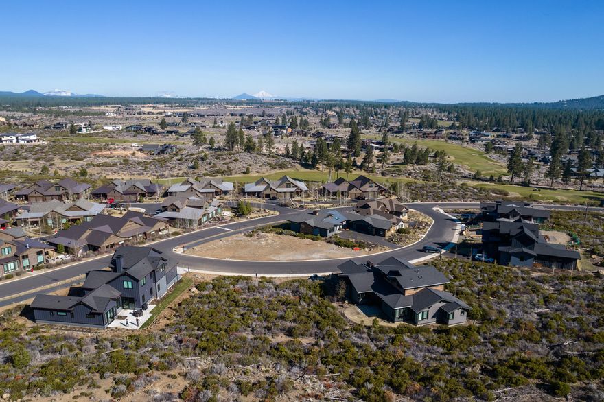 Build your dream home on one of the last remaining lots in award winning Tetherow Resort. This flat .21acre lot is situated above the road offering a lifetime of protected panoramic views, while also backed up to a beautiful rock outcropping. Alpine Park and common area for guaranteed privacy. Tetherow offers world class golfing, three on site restaurants, miles of walking and biking trails, fitness center, pool, and easy access to Mt. Bachelor ski resort, cascade lakes and all that Bend has to offer. This is a must see and won't last long!