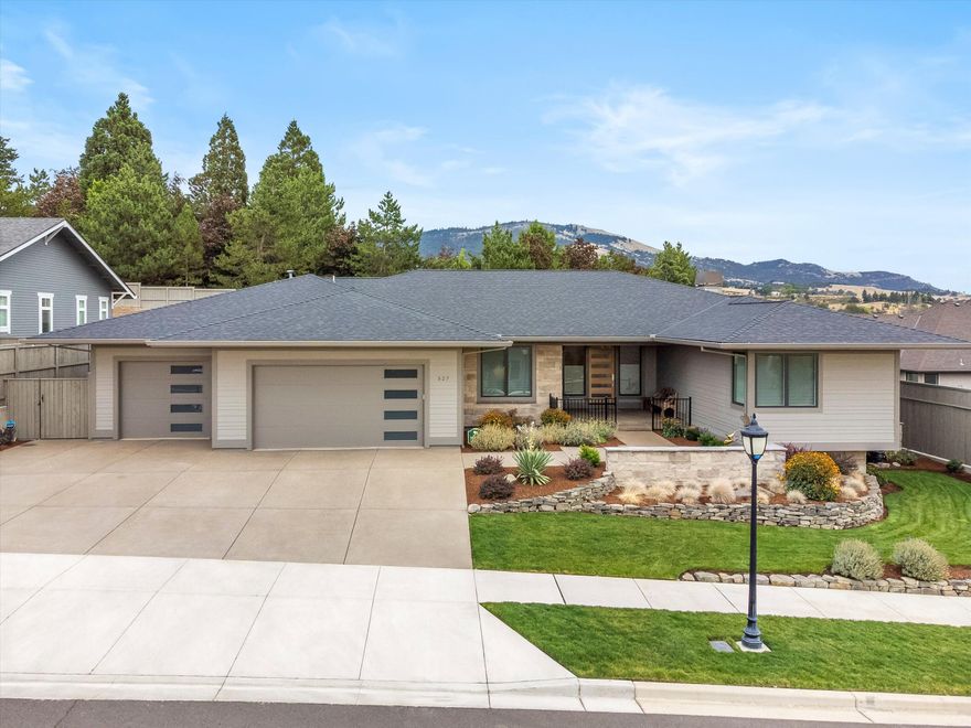 Welcome to this sophisticated, contemporary residence w/ a vibrant, artistic flair located in the desirable Summerfield Subdivision. As you step inside this beautiful home, you're greeted by the stunning modern design elements, creating a space that is both unique & inviting. Newly built in 2022, this meticulously cared for 2,965 SF home features an expansive great room w/ fireplace, plank wood flooring, 10-13ft ceilings & windows that flood the interior w/ natural light. The heart of the home features an expansive kitchen, abundance of cabinetry, lg center island, stainless steel appliances, pantry & wet bar. Relax in the elegant primary suite and spa-like bath, with spacious closet. Outdoor living boasts a covered patio inviting you to unwind & soak in the tranquility and MT Views. Additional features: Split floor plan, custom window treatments, central vacuum system, tankless water HTR, over size 3 car garage,100ft extra wide lot & Earth Advantage Certified. An absolute must-see!