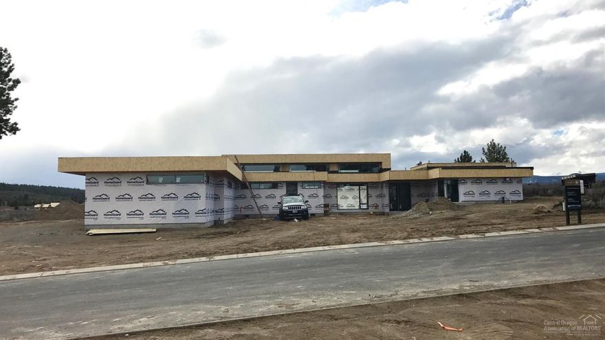 An incredible contemporary home underway in Tetherow will be completed this Summer. This single level home boasts progressive design that captures gorgeous mountain views. It sprawls across a .96 ac lot and invites you to vaulted open spaces including a stunning great room, three suites, office and bonus area. A signature glass accordion wall opens to outdoor covered living designed to entertain overlooking the Cascades. A collaboration between Design Haus and Bend Trend Homes that will not disappoint!