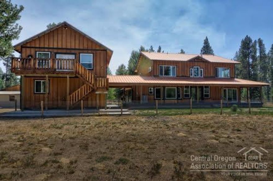 Great hobby farm on small acreage. Property is fenced and crossed fenced with 2 loafing sheds. The amazing home was a builders own home so offers many upgrades.Granite counters, 2 master suits, one upstairs, one down stairs, large walk-in closets, bamboo flooring, large windows to let in the light and view the public land adjacent. The wonderful wrap-a-around porch and stone patio allows the enjoyment of the outdoors. 2 car attached garage and 4 car detached garage with shop area. Must see!