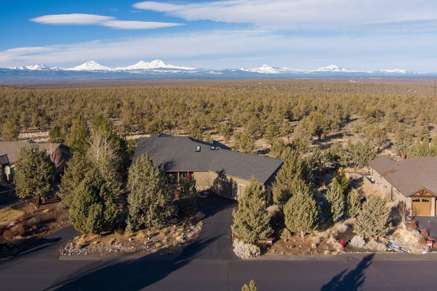Single level custom home in Eagle Crest w/panoramic cascade mountain views that backs community property/BLM land that flow uninterrupted for miles! Eagle Crest is a premiere resort community w/3 golf courses, several pools/fitness centers, sports courts, trails, & public land access on all sides. This home features a great room design w/single piece solid surface island w/breakfast bar, a spacious dining area w/views, & living area that has a fireplace w/hearth & access to the covered back porch. The master suite is spacious, private, & has a double headed/tiled shower, a well-organized walk-in closet, & access to the deck. The guest bedroom is on the opposite side of the house & is adjacent to the guest bath. The two bonus rooms could each be used as a 3rd or 4th bedroom w/the addition of a closet. The attic has been developed into a beautiful enclosed/heated view-deck w/sliding doors & outside area as well. The 2-car garage is 956sf & fits 2 pickups/SUV's & all your outdoor gear!