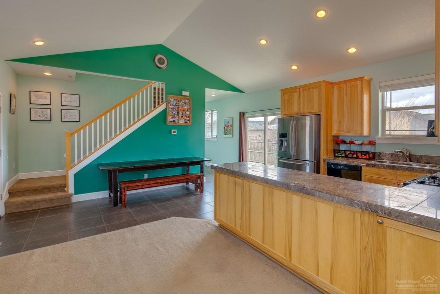 Priced to sell! Situated on a corner lot in desirable NW Redmond - hard to find 4 bedroom 2.5 bath home. Enjoy the Main Level Master suite w/direct access to the fenced back yard. Additional 3 bedrooms & loft area upstairs. All bedrooms and living room have ceiling fans. This home features tile floors in high traffic areas, open rail stairway, custom Hickory cabinets, tiled counters throughout. Mudroom laundry w/utility sink & plenty of space. Gas forced air heat, A/C, tankless hot water heater. Cascade mountain views, RV parking w/hook-ups, low maintenance landscape w/auto sprinklers. Easy access to schools, amenities & the parkway. Don't miss out on this great home!