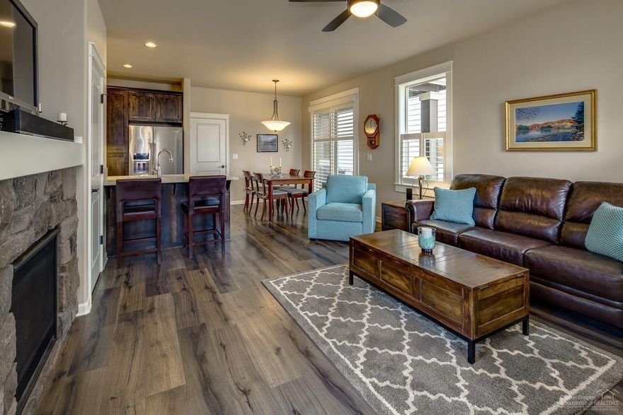 Easy Lifestyle Awaits with stylish Pahlisch home ready to move into for Summer. Nearly new, you'll think it's a model. Kitchen offers upgraded KitchenAid Appliances, refrigerator, Solid Surface counters. Custom plantation shutters, White wood wrapped windows, handsome laminate flooring on main floor, AC installed. Garage has additional storage area. Clubhouse, gym & pools are a quick walk. Open floor plan w/ loft suits many lifestyles: Downsizing, Young Family, Single Professional or Dream Vacation Home.