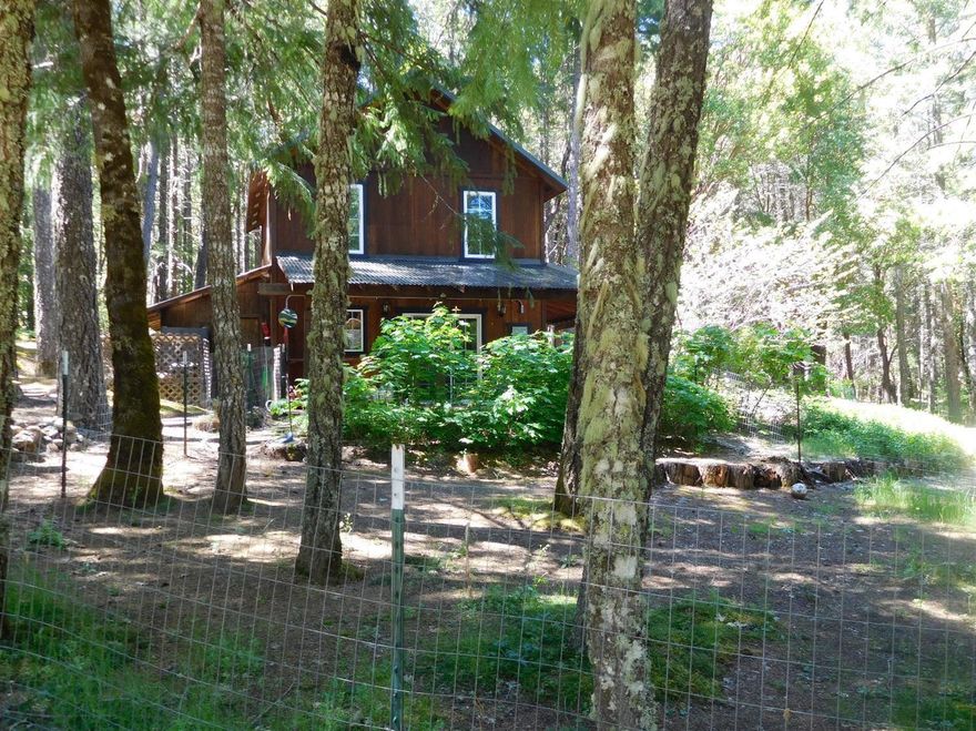 Very nice, newer 2-story home that fits right into its perfect setting. You may feel like its your cabin in the woods, in a serene setting. Comfortable for anyone that just needs to have enough room, that is well maintained, but not too much to take care of. Of course, there is lots of room for expansion, for those who need more.Wonderful trees, variety of conifers, and hardwoods. Owner has ornamental trees, and landscape that is easy to maintain. A fenced garden, with raised beds, and a handy 6 X 8 garden shed close by for all the tools you need. Water to the garden area. Close by is an arbor, covered with beautiful Wisteria, and a perfect bench to relax on. Home sits up on a slight knoll, where you can view the garden area and open areas, that are dotted with trees. Pond is year round, but does get a little low in late summer. Spring may be improved upon. Certified wood stove to keep you warm. Lots of kit. cabinets, lg. master bath up. Wood shed, & clean shop. fenced area for dog.