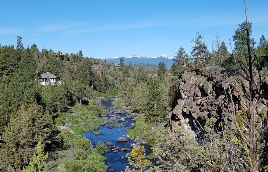 This home has one of the most beautiful views of the river and mountains!  Enjoy the beauty and the peace and quiet while relaxing on the deck.  It seems like you're miles away , but you're really so close to town. This home boasts vaulted ceilings and floor to ceiling windows to take in the view.  Open kitchen, dining and living room makes it an easy home for entertaining.   Bedrooms are both downstairs.   Off the primary bedroom is an office/nursery/craft room, which then leads to a beautiful outdoor entertainment area.   Bathrooms and kitchen have all been remodeled.
There is a very nice storage shed with electricity.   Next to the garage is a carport area for a 3rd vehicle or boat, with lots of storage for all your toys.
21 new solar panels generate electric power to reduce the electric bill significantly.
Septic was totally redone in September 2024.  New decks on lower level.