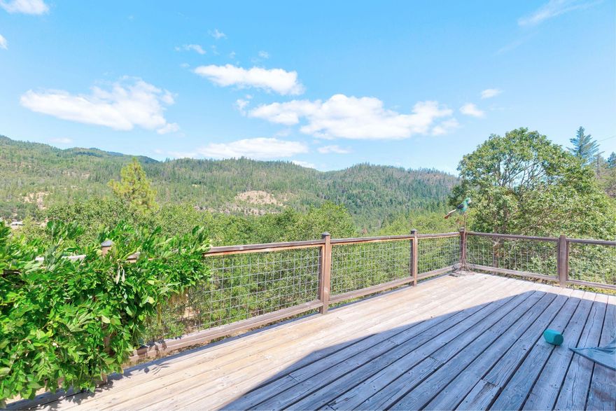 Discover this one-of-a-kind custom home by Dan Loper, nestled on 7.25 gated and fenced acres with breathtaking valley views. This 2,208 sq ft 3-bed, 2.5-bath home features a finished daylight walkout basement perfect for guests or rental. Enjoy 3-inch black oak hardwood floors, a Lopi wood stove, Hunter Douglas blinds, 2023 dual mini-split HVAC units, and a durable metal roof. The wraparound and view decks offer incredible outdoor living. The lower level includes a mini-bar, half bath, and separate entry—ideal for multigenerational living. Outside, find a 26×30 shop with 220v on its own meter, a fully insulated she-shed, 2-car garage with carport, and 90×70 animal pen. Septic and high-pressure well in place. Kitchen and baths feature tile updates from 15 years ago—well-maintained and ready for a modern refresh, offering instant equity and customization potential. Clean, functional, full of character—this property is your chance to live the country dream just minutes from town.