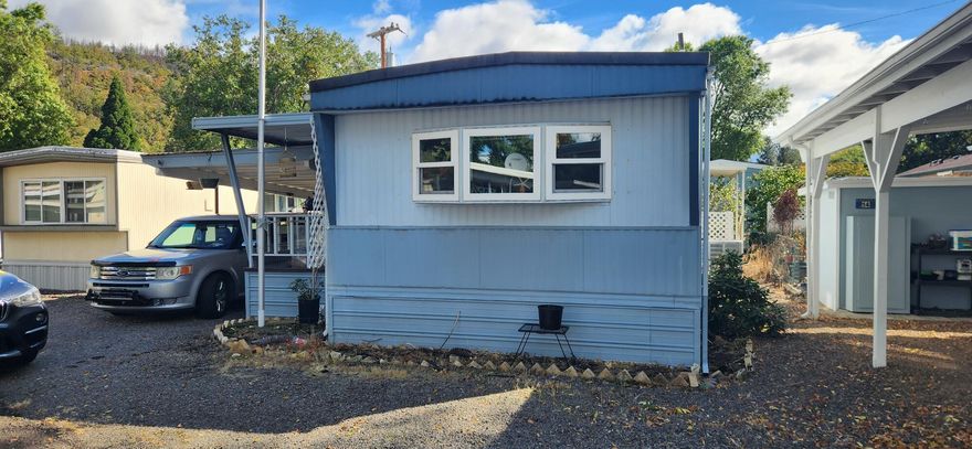 This home is in the Paradise Mobile Home Park and is a 55+ community. It features 2 bedrooms, 1 bath with a walk-in shower. There is forced air heat and A/C (heat pump) to you keep you comfortable all year long.  The living room and kitchen have newer flooring (per the owner). There is an attached carport, a covered front porch and 2 sheds. All of the appliances are included in the sale. Call and schedule your showing today!