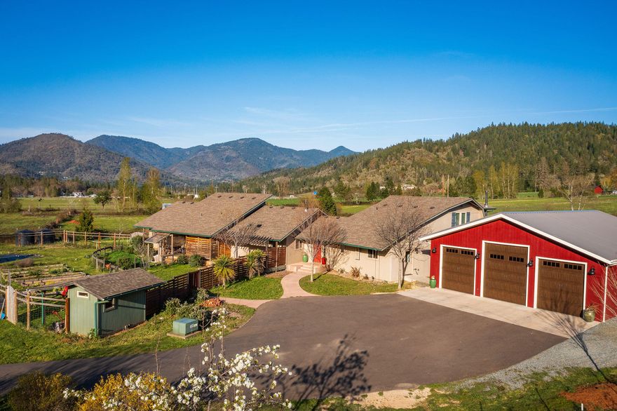 This fabulous piece of property is an Organic  Tilth Certified Lavender Farm situated at the entrance to the beautiful Applegate Valley.  Two gorgeous homes  - the first 3377 sf remodeled in 2010, vaulted ceilings, hardwood floors, two master suites, one upstairs and one downstairs in addition to two more bedrooms.  The downstairs suite has it's own private deck with a view of the gardens, small vineyard and fruit trees just outside and outside shower!  Nicely appointed kitchen also opens onto 2 private decks; one side with benches, and  the other is an outdoor kitchen/potting area.  4 car detached garage with RV storage/parking.  Second home built in 2017, 1724 sf with stunning windows in the living room to take in the view, hickory floors, beautiful kitchen with high end appliances, master suite with office in back, huge walk in closet and lovely master bath and guest bedroom.  Detached garage with climate controlled room in back.  Chicken coop, barn, 2 ponds and irrigated - Wo