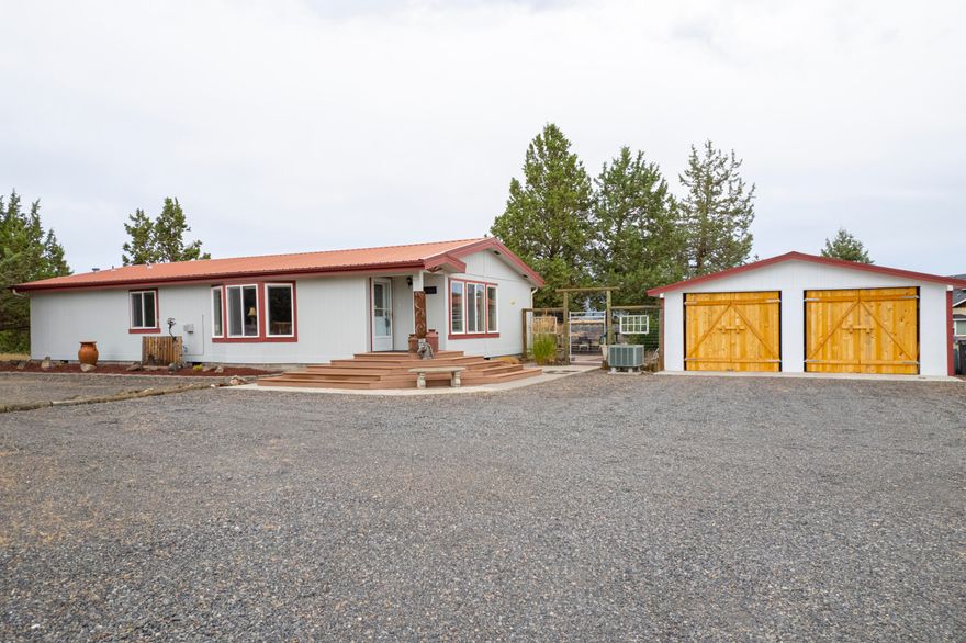 Located on 1.46 of an acre at the rim of Crooked River Ranch with amazing canyon & Smith Rock views. This 3 bed, 2 bath 1370 SqFt MF home features an open floor plan, built in pantry, granite countertops, breakfast bar & tile floors in the kitchen and dining area. The living room has a gas fireplace, vaulted ceilings & wood floors. There is a sizable primary bedroom with a walk in closet, double vanity & large shower stall. As you exit the laundry/mud room to the fenced backyard you will find a paver patio, covered gazebo, water feature & raised garden beds. Fresh exterior painted. There is a detached 2 car carport with barn doors & workshop on the backside of the carport. Call today for a showing!