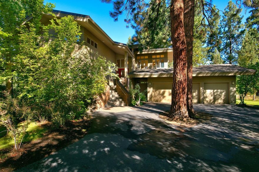 NW Style home on .53 acre lot in the desirable Broken Top Neighborhood and Golf Course. Custom Home is 3512 sq ft, 4 bedrooms, 3.5 bathrooms, living room with fireplace, open floorplan with kitchen, dining room, breakfast nook and master upstairs with access to private decks. Downstairs is a large family and/or office, 3 bedrooms and 2 updated bathrooms. Hardwood and tile floors though out home with attached 3 car garage and large laundry room. Setting is private and overlooks the driving range. The gated community includes golf, restaurants, park with playground, walking paths and lakes.