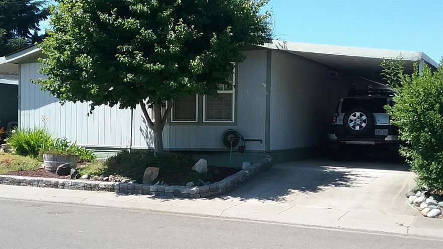 This is the best home in the park, that's what the neighbors say! This super cute and well cared for home is ready for the new owners. The landscaping is awesome and low maintenance since it is on a sprinkler system. The shed in the driveway stays and the shed in the yard stays, so you have lots of storage. Very open split floor plan and lots of windows for great sunshine. You have to take the time to tour this home and write an offer asap, it won't last at this price. There is a covered carport on one side and a covered deck on the other. All blinds and appliance stay except the washer and dryer. This includes the freezer in the carport shed. Come out and see it! All information deemed accurate, buyer to perform their own due diligence.