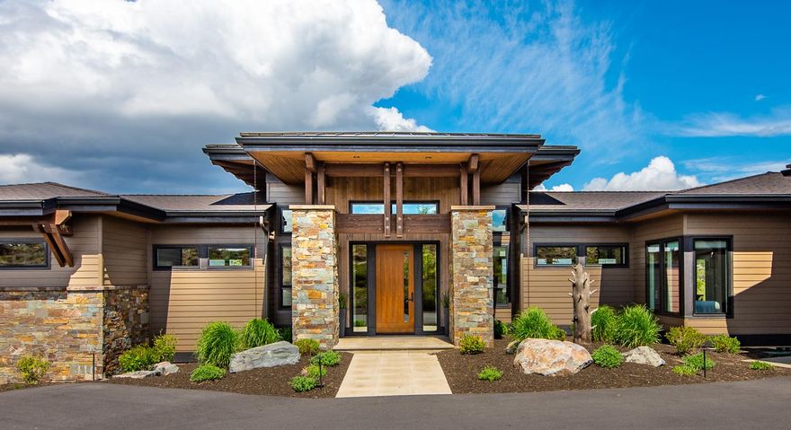 This custom built, single level, Tetherow home providing a secluded setting overlooking the 11th fairway of the golf course, is a must see!  Tucked in a quiet cul-de-sac with common space on three sides, this industrial mountain modern design features an open design with sweeping views overlooking the golf course and Pilot Butte. This home boasts unique design features such as a board formed concrete fireplace, rich reclaimed wood accents, and a sleek temperature controlled 360-bottle wine storage wall. The gourmet kitchen features double ovens, sink with double faucet, solid quartz countertops and commercial grade appliances.  Two spa-like suites on opposite ends adds separation and privacy.  The design of the third bedroom allows for flexibility to be used as an office, exercise or game room.  Accordion sliding panel doors allow the outside in! Enjoy entertaining under a covered patio with built-in fire pit. Epoxy-covered 4-car tandem garage is ideal for storing all your toys.