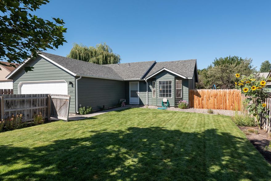 This welcoming single level home has been freshly painted on the exterior, including a new garage door, along the back are new windows and slider, plus electric shutters.   In the backyard, enjoy  the recently installed composite deck that leads you grass with automatic sprinklers (both front and back).   Inside, is the open floor plan with a vaulted ceiling and roomy kitchen with a breakfast bar.  Down the hall are the 3 bedrooms and 2 baths.   A separate laundry room gives you access to the double car garage.  Fully fenced front and back.