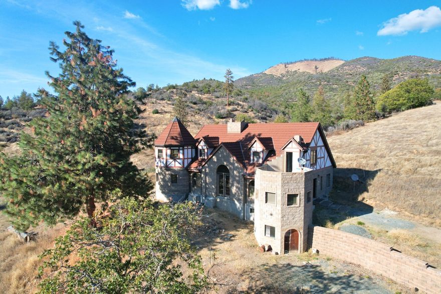 Castle on the Hill with the Views to Expect! Solid concrete & steel construction inside & out. Multi-zoned hydronic heating plus woodstove w/ venting system to deliver heat throughout the house. Full daylight basement w/ fantastic workspace & storage. Knoll-top setting overlooking views of mountains & neighboring farms. Large level area to the southwest is a great area for large pool or your own ''enchanted'' garden. 79+ rolling acres w/ water rights & BLM border for miles of trails. Solid 1296 sq.ft. feeder barn w/ equipment storage on the lower level & the 1600 sq.ft. shop w/ 2 bays give you ample space for animals & projects.  From an exotic B&B to an equine oasis, this ''ready to finish'' property is ready for the best of visionaries. It is a fantasy in the making.