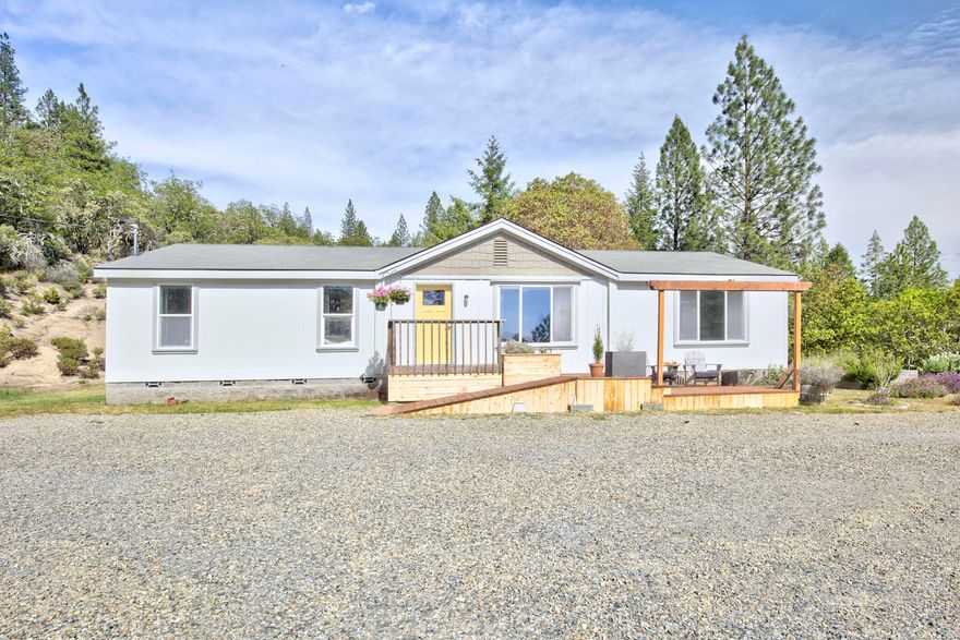 Gorgeous panoramic views set the stage for this recently updated home privately set on 5 acres in Southern Oregon!  With great southern exposure featuring a 4 bedroom 2 bathroom manufactured home with lots of natural light, split bedroom floor plan, new laminate flooring, freshly painted inside & out & cement board siding.  Spacious kitchen with island and ample storage that leads to laundry room/pantry area.  Living room with vaulted ceilings highlighted by a picture window framing your SW view perfect for enjoying those sunsets.  Primary bedroom set off living room with walk-in closet & en-suite bathroom.  Three additional bedrooms set down the hallways w/ guest bathroom including tub/shower unit and solar tube.  Plenty of room to garden in this tranquil setting w/ flat areas around the home and outbuildings for storage.  Room for a shop & RV/Parking w/ sewer and water hookups.  Approx. 10 minutes to Grants Pass and shopping, restaurants, medical and more!  Call today for a tour!