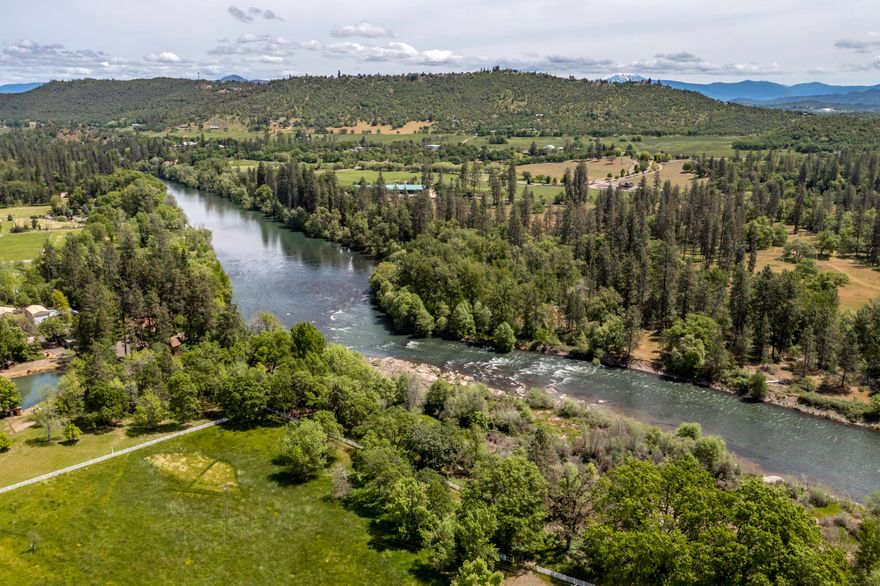 This riverfront property is incredible & versatile! Located on one of the most desirable stretches of the Rogue River with approximately 200 feet of river frontage. The enclosed warehouse/arena is approximately 25,000 sq ft w/ lighting, sprinklers, drainage, steel support systems & heaters. 4 large bays w/ brand new concrete floors throughout, which allows for many uses! Irrigation rights on 20+acres! 600 amps single phase service w/ access to 3 phase power at street. Paved & gated entrance! The main barn features eight stalls & tack room. The secondary barn features 12 stalls & is perfect for animal boarding or storage. 160 ft round pen. 1,000+ sq ft equipment building. 4 pastures that are fenced & cross fenced w/ quality vinyl fencing, totaling 16 acres. The home has been cared for & holds the perfect location to build your dream home! Incredible views of lower Table Rock! This property is located within 15 minutes of the conveniences of Medford, the airport & I-5.