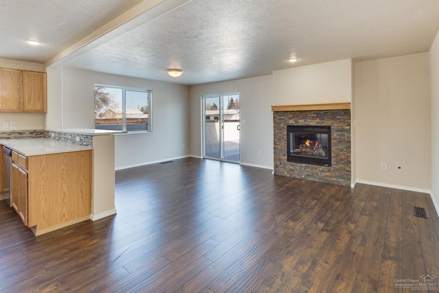 Crossing Townhomes! Completely updated w/new paint inside & out. Laminate floors on the main level. Great room has stacked stone gas fireplace/sliding doors to vinyl fenced backyard/patio. Quartz countertops w/stone & glass backsplash. Great kitchen-new stainless appliances, breakfast bar & more. 1/2 bath & under stairs storage on main level. Carpeted upstairs w/nice separation of bedrooms & utility room to make laundry easier. Single attached garage. Easy access north or south