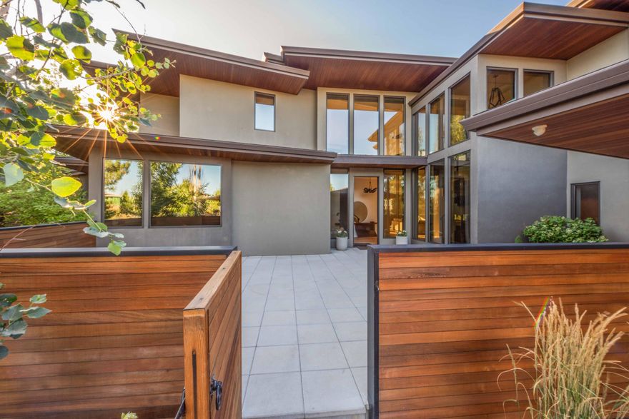 Ensconced in a private enclave of homes where National Forest meets Tetherow resort, this modern contemporary is the epitome of effortless luxury. Here, a beautiful mix of tongue & groove cedar, stucco, and walls of glass, deliver light, nature, and style at every turn. The inviting gourmet kitchen features top-of-the-line appliances, a generous island, and stylish matte-finish painted cabinetry. In the serene master suite owners wake to an unobstructed mountain view, and start the day with spa-like amenities including a free-standing tub, steam shower, custom closet, private fitness/office space. Upstairs, enjoy some of the finest mountain sunsets in all of Central Oregon from the open media space and adjoining balcony. Two additional ensuites, each with distinct charm and style, offer ample space for all.  The outdoor space offers a built-in pool, extensive patios, lush landscaping, and the show-room quality three car garage. This is the home for which you have been waiting.