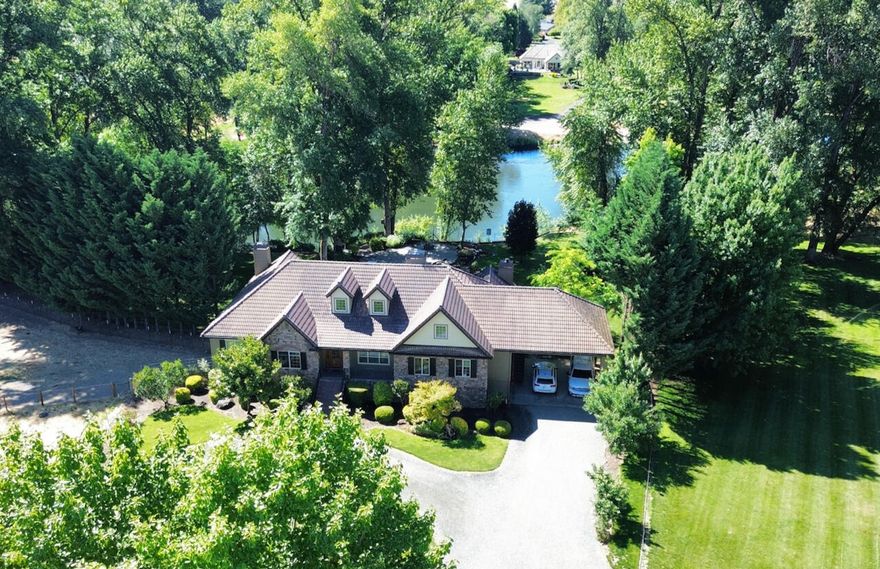 Nestled along the Rogue River, this estate spans 6.8 acres. With 800+/- feet of frontage this is an angler & nature-lover's dream! Among its remarkable features are the custom home w/ FEMA approved engineered foundation, 3 fireplaces, instant hot water throughout, office, 4th bedroom w/ plumbing, formal dining, well appointed kitchen with granite counters, high end stainless appliances, large pantry, carport with stair lift & 2 bed/1 bath apartment above the 4 bay garage with 220 & half bath. The level property has lush, landscaped yard with patio overlooking the river, fenced garden with raised beds, district irrigation, expansive deck & stairs down to the river's edge. The property is a true ranchette with cross-fenced pasture, 50 gallon per minute well when last tested, 36x36 barn with 3 stalls & hay/equipment storage. Located only 4 miles from historic downtown Grants Pass & 30 miles from the Medford Airport. This Rogue River estate harmoniously merges luxury, nature & convenience