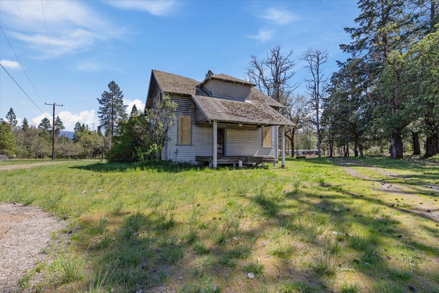 Possible owner carry! Marvelously Unique Rural Commercial Property with RV Parking! Conveniently located just off U.S. Route 199, this property offers an array of possibilities with 2.84 acres of sprawling land, a gated entrance, and a 2BR/1BA home. Presently in rather rough shape, the approximately 1404 sqft residence features a covered front porch, hardwood flooring, a living room with a spot for wood stove, a kitchen, two bedrooms, and a full bathroom. Explore the outdoor space to find an additional structure/potential storage building. As a bonus, the property also has a well and two septic tanks. Take advantage of the exceptional location and enjoy the wonderful shopping and dining in nearby Cave Junction. Situated only 7.7-miles from Downtown Cave Junction, you are within minutes of Dutch Bros. Coffee, Wild River Brewing and Pizza, Carlos Restaurante, multiple schools, parks, medical facilities, and grocery stores, and much more! Call now!