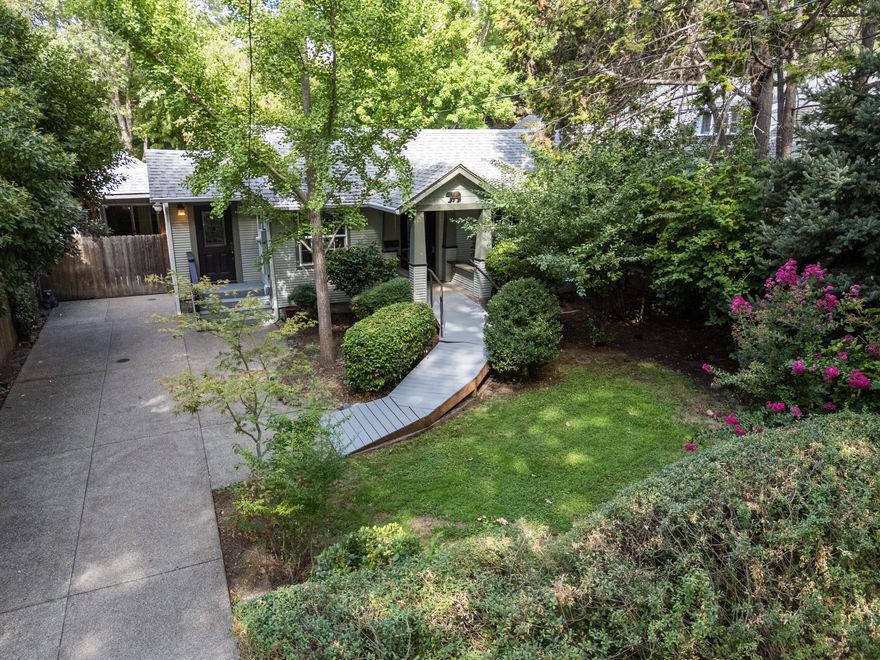 This nicely renovated 1928 Craftsman is known to many as ''The Bear Cottage.''. It sits on beautifully landscaped lot with flowering vines, mature trees, hedges and springtime blossoms. Many updates over the years have will have you living in modern comfort including, vinyl double pane windows and central HVAC. Kitchen with its  beautiful cabinetry is opening to the living space with a soaring ceiling. Two bedrooms, each with their own full bath. Be sure to check out the detached 324 sq/ft space with ductless HVAC, most recently used as an art studio and music room. The most excellent Grants Pass Farmer's Market, shopping, schools, banks are all within a mile of the very centrally located property.