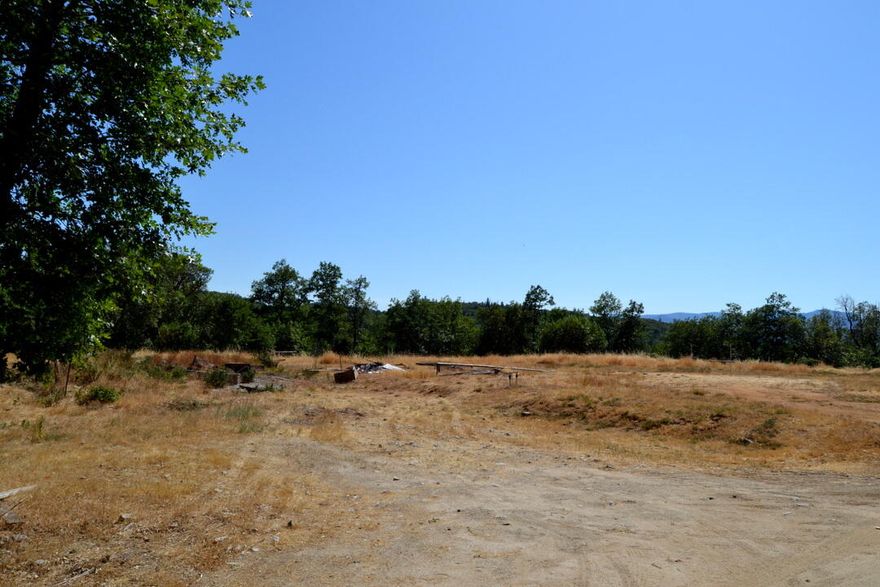 Beautiful 5+ acre parcel just one mile from Merlin and minutes to the I-5 on-ramp. This open, mostly level property is ringed with trees and offers great views in a peaceful setting. A rare opportunity to own usable land at a price well below tax-assessed value. Don't miss this chance to build or invest affordably in a prime location.