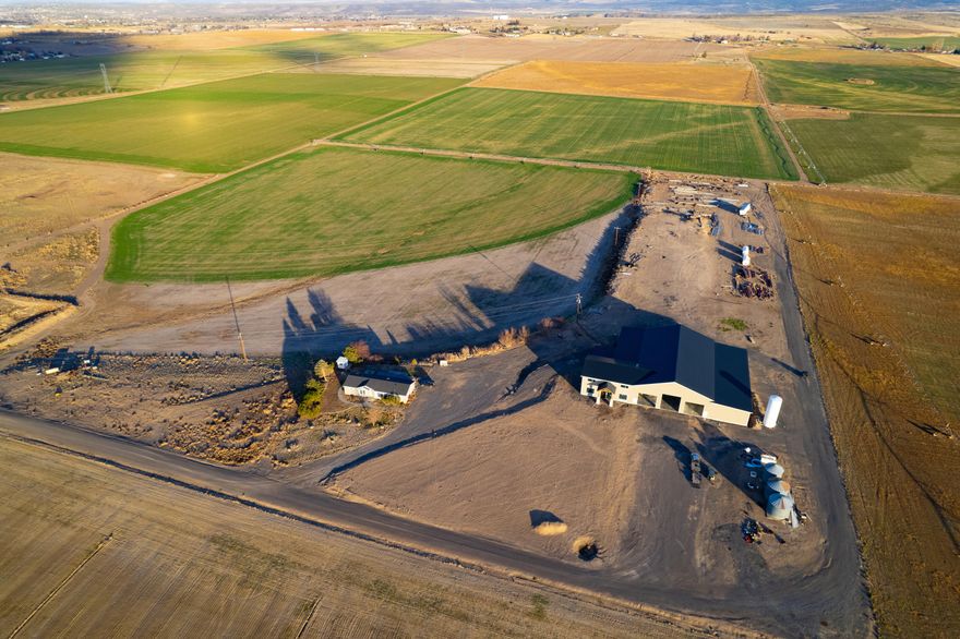 Outstanding opportunity to own this productive 417.79± acre farm adjacent to the small community of Metolius and just a short drive to Madras and Redmond for your farm supplies, shopping, and dining needs.  The farm's rich, loamy soils coupled with 392.2± acres of irrigation water rights (389.6± Deschutes River; 2.6± acres Crooked River) delivered by the North Unit Irrigation District should enable the production of all crops common to the area.  Irrigation distribution is aided predominately by Linear and Center-Pivot systems, with some wheel line.  The 1997-year doublewide mobile home provides onsite housing.  Put your finishing touches on the fantastic 17,395± square foot shop/machine storage/office structure and you have the ''shop'' envy of every farmer!  Don't miss this opportunity to get started in, or expand your farming operation, all while enjoying Central Oregon's Cascade Mountain views!