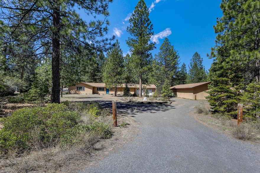 Surrounded by mature ponderosa pines, this home offers great value just minutes from downtown La Pine and close to Wickiup Reservoir. The 3-bedroom, 1.5-bath home features many updates, a versatile layout, forced air heat, air conditioning, and a wood-burning stove for those cold nights. In addition to the attached two-car garage, there's a detached two-car garage with extra storage. The circular driveway and low-maintenance yard provide plenty of space for parking and projects, and there's even a chicken coop out back. Recent improvements include a new well in 2023.