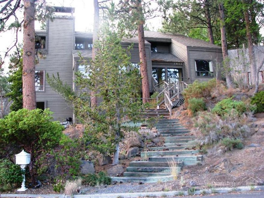 Dramatic West Hills 4 bdrm, 3 bath needs new loving owner. Situated on hillside boasting floor-to-ceiling stone fireplace, tall vaulted ceilings, lovely wood touches. Huge windows take full advantage of tree-top views. Outdoor living on trex-type deck off small greenhouse room. Main-level living except 4th loft bedroom off family room. Master suite includes walk-in closet, double sinks, separate shower and tiled tub. Complete with separate utility, double garage + shop area, private back yard.