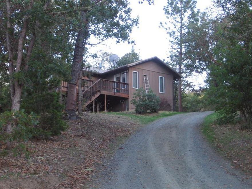 5acres with 2bdrm 1.5bath home & 1bdrm 1 bath studio. Main house was Remodeled in 1993 & features 2bdrm 1.5bath, den/office or possible 3rd bdrm, living room, dining in kitchen, downstairs finished basement features a bedroom, full bath, laundry &space currently utilized as a gym/workout room. There is also additional living space utilizing the 873sqft studio located above the shop/garage which has a living room, Full Bath, Kitchen & separate bedroom. The shop/garage is 528sq ft & shop is wired w/220 great work space for woodworking or metal work. Driveway with Gated access (automatic locking gate accessible by security code). Circular dive around house for ease of maneuverability & carport for extra parking. Great property for someone wanting privacy & rural property with the convenience of being close proximity to town.