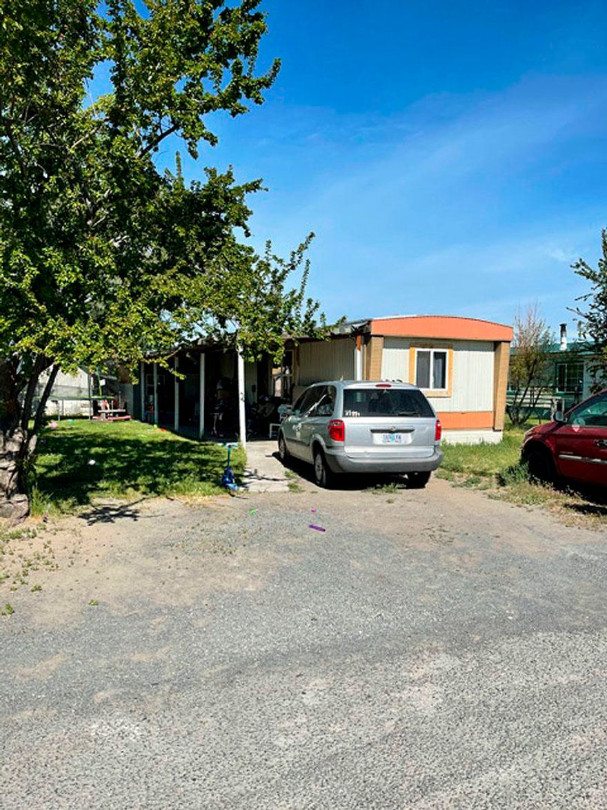 2 bedroom , I  1/2 bath manufactured  h om e, l ocated o n a d ead end street. This home features  newer membrane  roof, laminate flooring,  cute yard, storage, and covered  carport.   Easy to show.