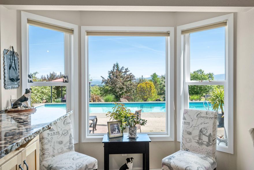 This stunning property offers breathtaking views of Mt McLoughlin, thoughtful design, and a dream layout for both indoor and outdoor living. Inside, you'll find two luxurious upstairs master suites—one featuring a private balcony to take in the stunning view of the valley. The main level hosts a comfortable guest bedroom and full bathroom, plus a beautifully updated kitchen with granite counters, stainless steel appliances, breakfast bar, and an oversized pantry that doubles as a hidden office nook.
Step outside to a sparkling in-ground pool, beautifully landscaped grounds, and  fully fenced and cross-fenced pastures with shelters ideal for horses.  The detached barn/shop provides endless possibilities for hobbies, storage, or livestock.  All this plus a new roof, heat pump and pool pump and 20 gpm well  tucked behind a gated entry for added privacy and peace of mind. So much to offer on this little piece of paradise!