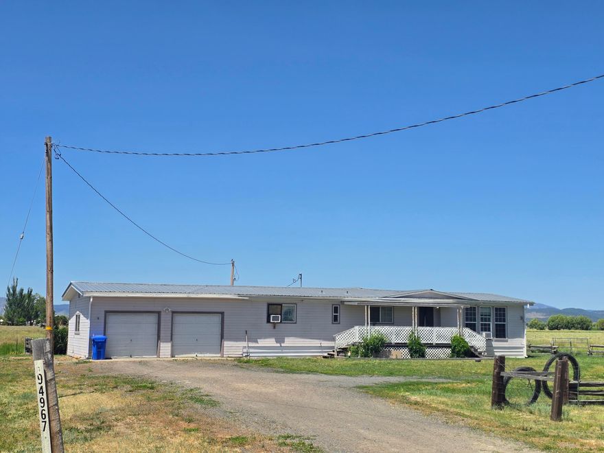 This 3-bedroom, 2-bath home offers wide-open living just minutes from Lakeview, with sweeping views of the Warner Mountains and productive pasture ground all around. With easy year-round access off Hwy 140, it's an ideal setup for those looking to get out of town and into clean country air. The home features a durable metal roof, an attached two-car garage, and a shaded front porch. The backyard features a fenced lawn, a fire pit, and ample space to relax or entertain. Inside, you'll find a functional layout with a central living area, practical kitchen, and laundry/mudroom entry. The property is served by a well, septic, and overhead power. Out back, there's ample open ground and a small livestock shelter-perfect for 4-H and FFA projects, backyard poultry, or hobby-scale gardens. Plenty of space to build out your vision without starting from scratch. Whether you're a first-time buyer, young family, or someone looking to reconnect with rural life.