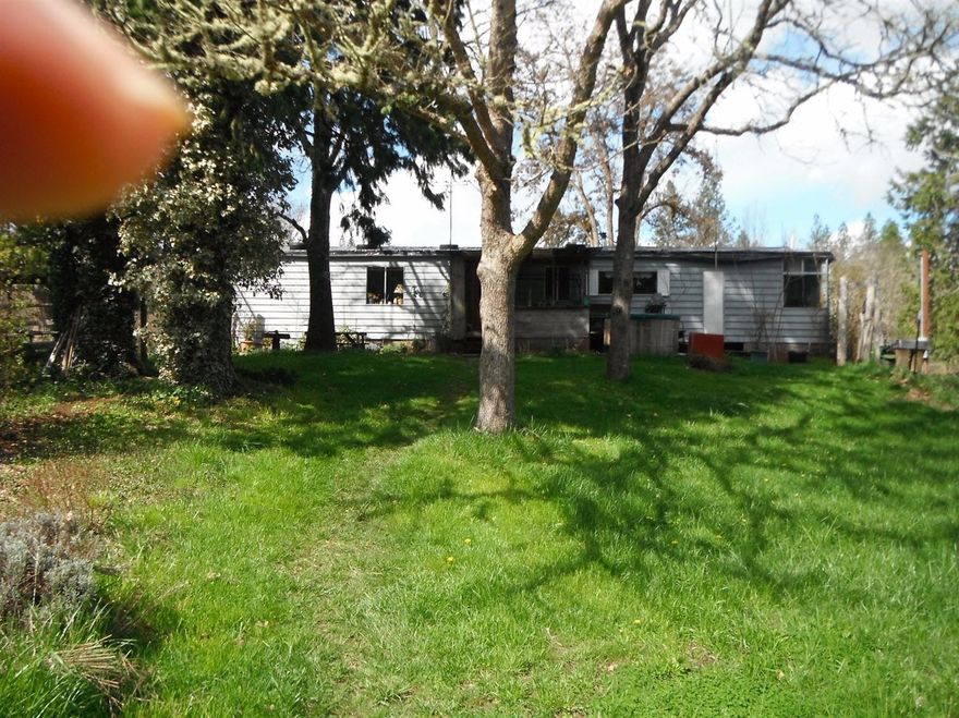Hard to find level 15.2 acres with water rights in the beautiful Williams Valley. the property has a 16 x 24 double wide mobile home. mobile home is in need of a new roof. Most of the value of the property is in the land and water rights. There is an existing hay barn with attached shop. buyer to do due diligence.
