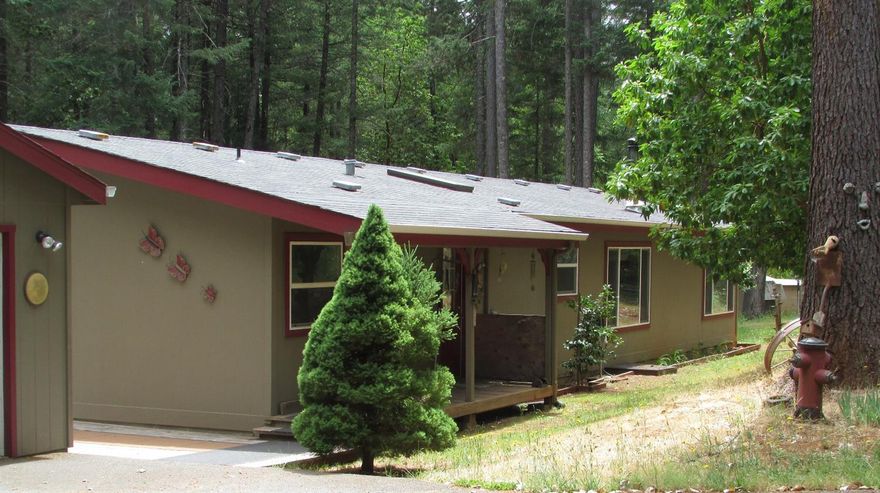 Lovely, partially secluded wooded 3 bedroom, 2 bath mfg. home with a family room. Open vaulted ceiling in the kitchen. Wood decking with cover surrounds most of the home. There is almost 1800 sq ft of living space. The garage has built in cabinets on both sides great for the do it your selfer. Plently of room for the vehicle!