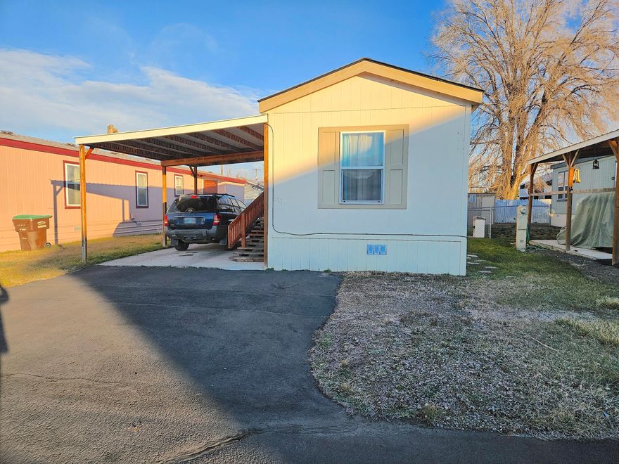 Walking distance to town and the library! Cute and spacious 2 bedroom, 2 bathroom mobile located in desired Queens Garden - 55 and over Mobile Home Park. Kitchen is open to living area with a nice sized island with laundry area close by. Primary bedroom/bathroom on one end of the has 2 closets and a walk-in shower while the second bedroom and guest bath are located at the opposite end of the home. Some nice finishing touches including some crown moulding through out the home. Nice sized fenced yard with 2 sheds and a covered carport. Space rent is $450 a month-inlcudes, water/sewer/garbage.