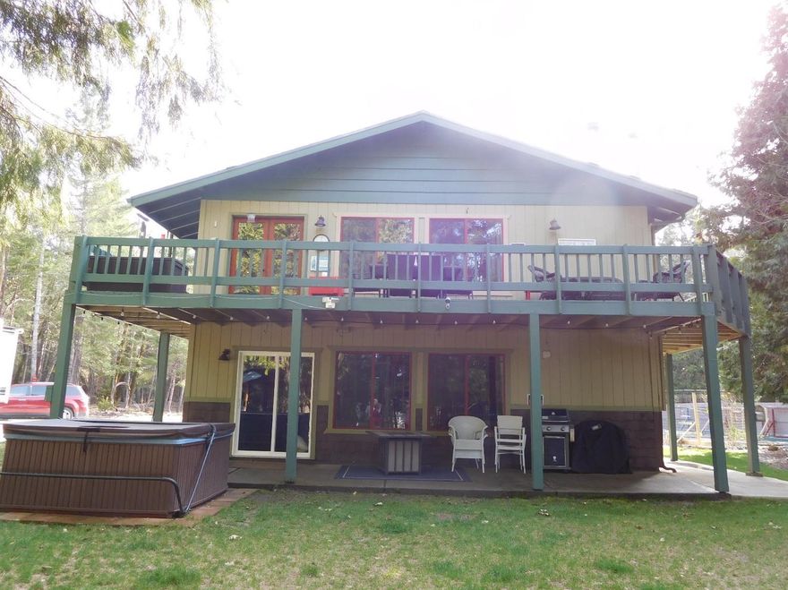 This is the Oregon Dream! Year 'round Deer Creek frontage for summer fun. Grow your own veggies in your fenced, raised bed garden and hang out on your upstairs deck all summer. Cool off in the creek or warm up in your hot tub. This fantastic home is picture perfect and move in ready. Downstairs family room has it's own wood stove adding over the top warmth and ambiance. There is a bedroom and bathroom downstairs for in-laws or guests? Upstairs living area has a wood stove, lots of knotty pine and vaulted ceiling. Lots of windows allow lots of light (all windows replaced in 2017). Custom country kitchen is attractive and efficient with all amenities you expect including granite counters and kitchen island. Upstairs wrap around deck provides view of gardens, orchards, herbs, flowers, and much more. Owners have invested their heart and soul so a new buyer can move in and enjoy. There is also a downstairs covered patio providing shade on a hot summer night. Recent appraisal indicates $349k